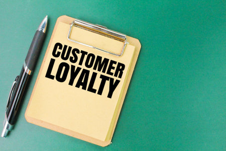 pen and book board with the word customer loyalty. concept of customer or clientの写真素材