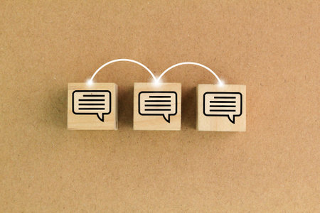 wooden cube with three boxes or conversation bubbles connected with lines. Concept of online communication or social networking.の写真素材