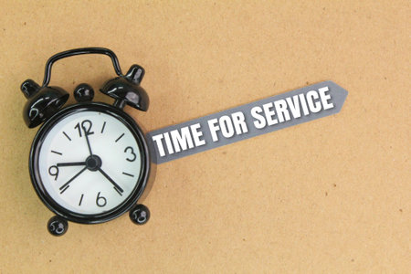 bell clock and tag paper with the words time for service. service conceptの写真素材
