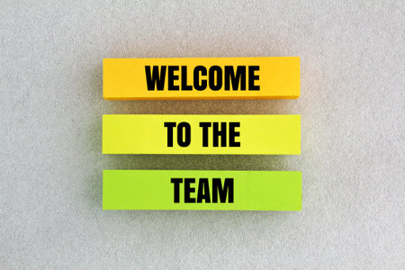 colored paper with the words welcome to the team. the concept of hiring new employees. teamwork conceptの写真素材
