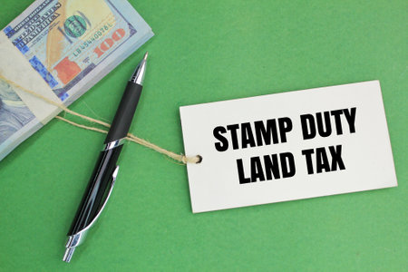 paper money, pens and tags with the words Stamp Duty Land Tax or the letters SDLTの写真素材