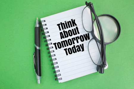 pen, glasses, magnifying glass and a book with the words Think about tomorrow today