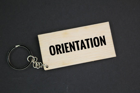 wooden tag with the word orientation. the action of orienting someone or something relative to the...