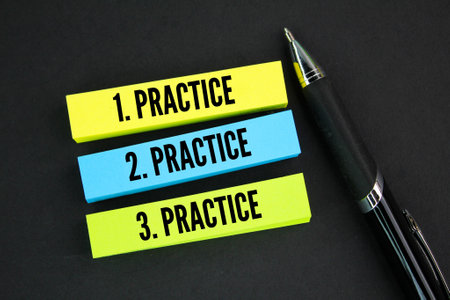 pen and colored paper with three repetitions of the words practice, practice and practice. consistent conceptの写真素材