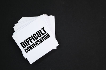 white paper with the word DIFFICULT CONVERSATION. difficult conversation conceptsの写真素材