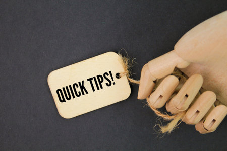 hands and wooden tags with the words QUICK TIPS!の写真素材