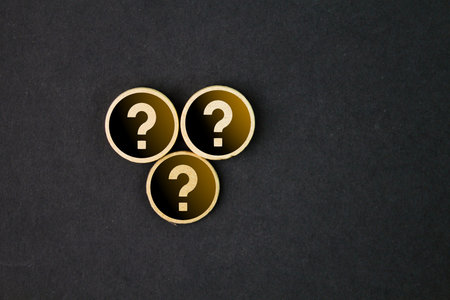 wooden round with three question marks. the concept of the question or HR