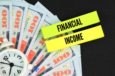 clocks, paper money and colored paper with the word financial income