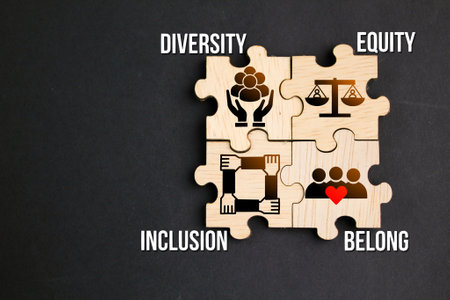 wooden puzzle with the words and icons of Diversity, Equity, Inclusion, and Belong or the letter...