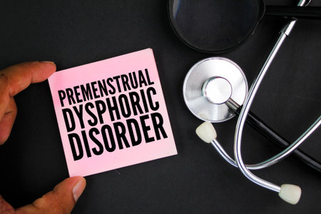 stethoscope and colored paper with the word premenstrual dysphoric disorder