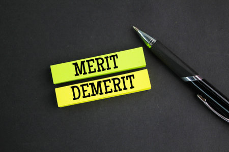 colored paper with the words Merit and Demerit. noun. a quality deserving blame. Merit, demerit and its retributions at the level of the individual.の写真素材