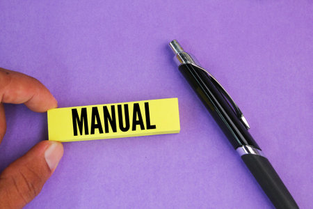 colored pen and paper with the word manual.の写真素材