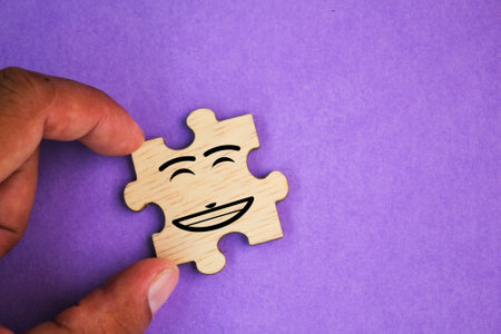 Happy smiley face icon on puzzle piece. Customer or customer satisfaction or positive feedback concept.の写真素材