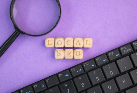 magnifying glass, laptop keyboard with the word local SEO. Business and finance concept.の写真素材
