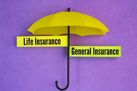umbrella and colored paper with the words Life Insurance and General Insurance