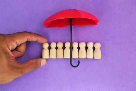 red umbrella and children's peg doll. the concept of child protection. the prevention of, and response to, exploitation, abuse, neglect, harmful practicesの写真素材