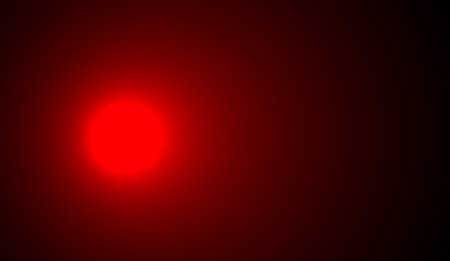 Dark background with red circle light on the side. Red dark gradient background. Defocused backgroundの写真素材