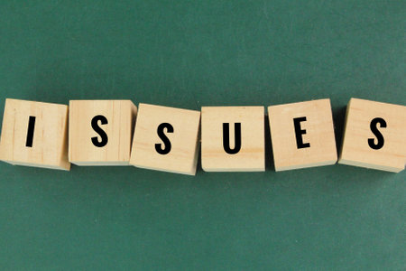 wooden square with the word issues. the concept of a problem or something raisedの写真素材