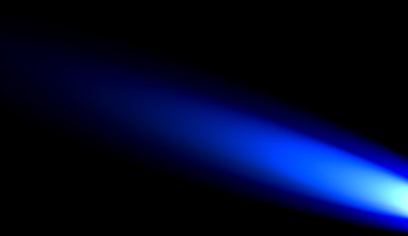 a small blue light in the upper left with a dark background. lights reflectors against black backgroundの写真素材