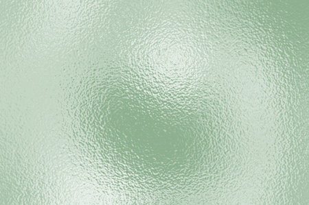 Soft green foil glass texture background. Abstract gradient bright light reflection and shiny rough...