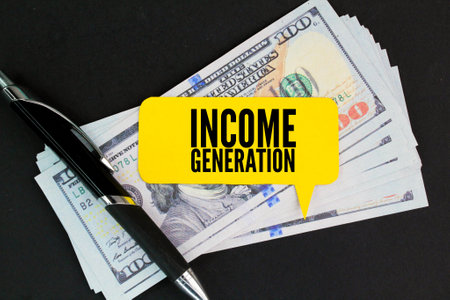 pen. paper money and yellow paper with the word income generationの写真素材