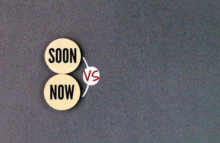 round light brown with the words soon vs now. indicates a future time that is not far off.の写真素材