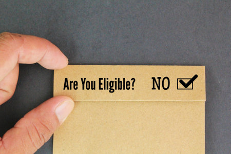 hand holding colored paper with question word Are you eligible? No answer the question concept of choiceの写真素材