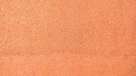 Abstract orange color cement wall background texture. Orange color dirty texture closeupの写真素材