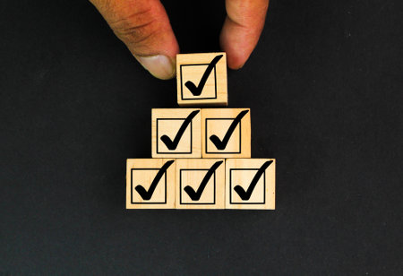Businessman stacking correct or right sign symbol which print screen on wooden block cube for document and project approve concept. Elections and Voting, Vote, to do list, checklisの写真素材