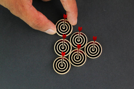 wooden circle with stack target icon. the concept of finding new targets. re-strategize. idea of marketing business money earnings aim,  strategy achievement, success targeting audの写真素材