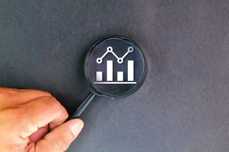 magnifying glass and graph chart. Checking financial reports. Graphs and charts. Symbolizes focus,...