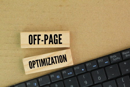 laptop and wooden keyboard with the word OFF-PAGE OPTIMIZATION. techniques used to improve a website's position in search engine results through actions taken outside of the websitの写真素材