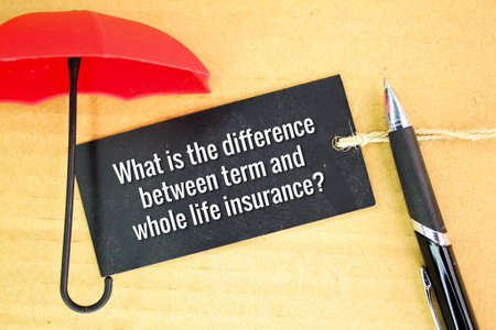 umbrella and pen with questions What is the difference between term and whole life insurance? insurance conceptの写真素材