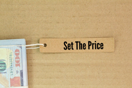paper money and paper tags with the words set the priceの写真素材