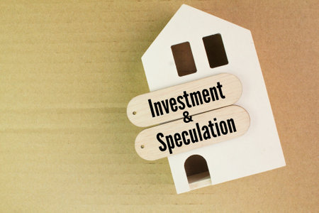 the shape of a wooden house with the words Investment and Speculation. the amount of risk involved.の写真素材