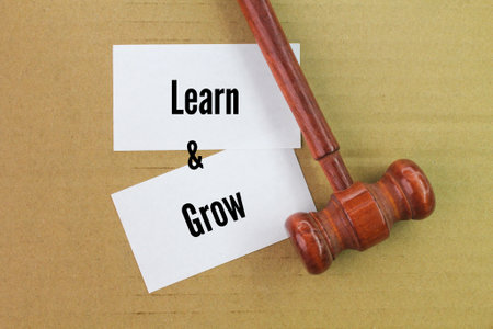 judge's gavel and white paper with the words learn and growの写真素材