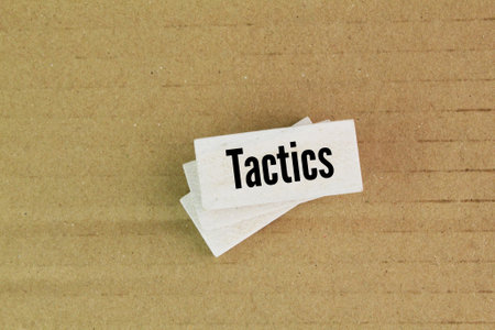 white stick with the word tactics. an action or strategy carefully planned to achieve a specific endの写真素材