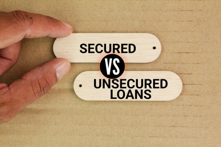 wood with the words Secured vs Unsecured Loan. Business loan conceptの写真素材