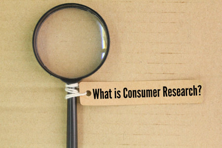 magnifying glass and tag paper with the question What is Consumer Research? customer service conceptの写真素材