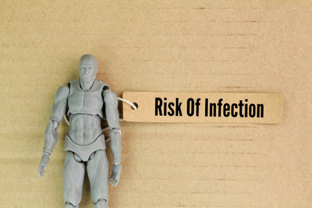 human body shape and a paper tag with the word risk of infection. disease infection concept