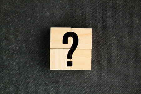 four wooden squares with big question mark symbols. the concept of a question or problem. Q and A....