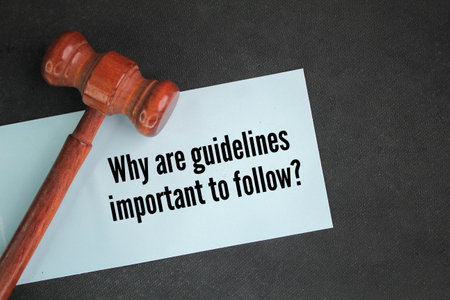 judge's hammer and paper with questions Why are guidelines important to follow? the concept of following the rulesの写真素材