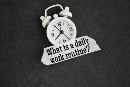 bell clock and stickers with the words What is a daily work routine? overtime concept