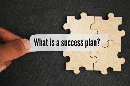puzzle and sticker with the question What is a success plan? concept of how to get successの写真素材