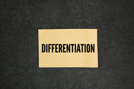 brown paper with the word differentiation. the action or process of differentiating or distinguishing between two or more things or people.の写真素材