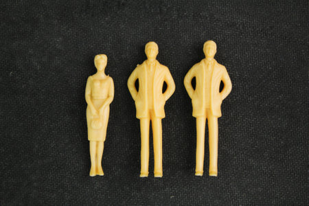 three miniature people placed or paired. Abstraction of a meeting, discussion, conversation. People discuss news and rumors.の写真素材