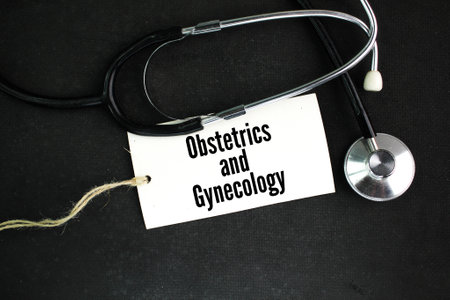 stethoscope and a paper tag with the words obstetrics and gynecology
