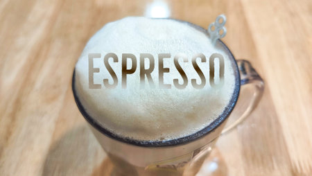 top view coffee mug with foam and the word espresso submerged in the foam. The view from above.の写真素材