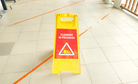 Cleaning progress warning sign. Sign showing warning of wet floor.の写真素材