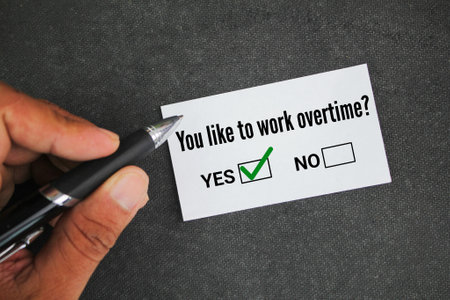 pen and paper with the question do you like to work overtime? answer YES. overtime conceptの写真素材
